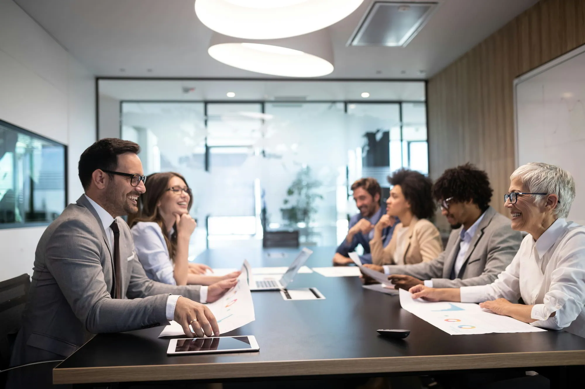 Professionals discussing B2B market research around a conference table
