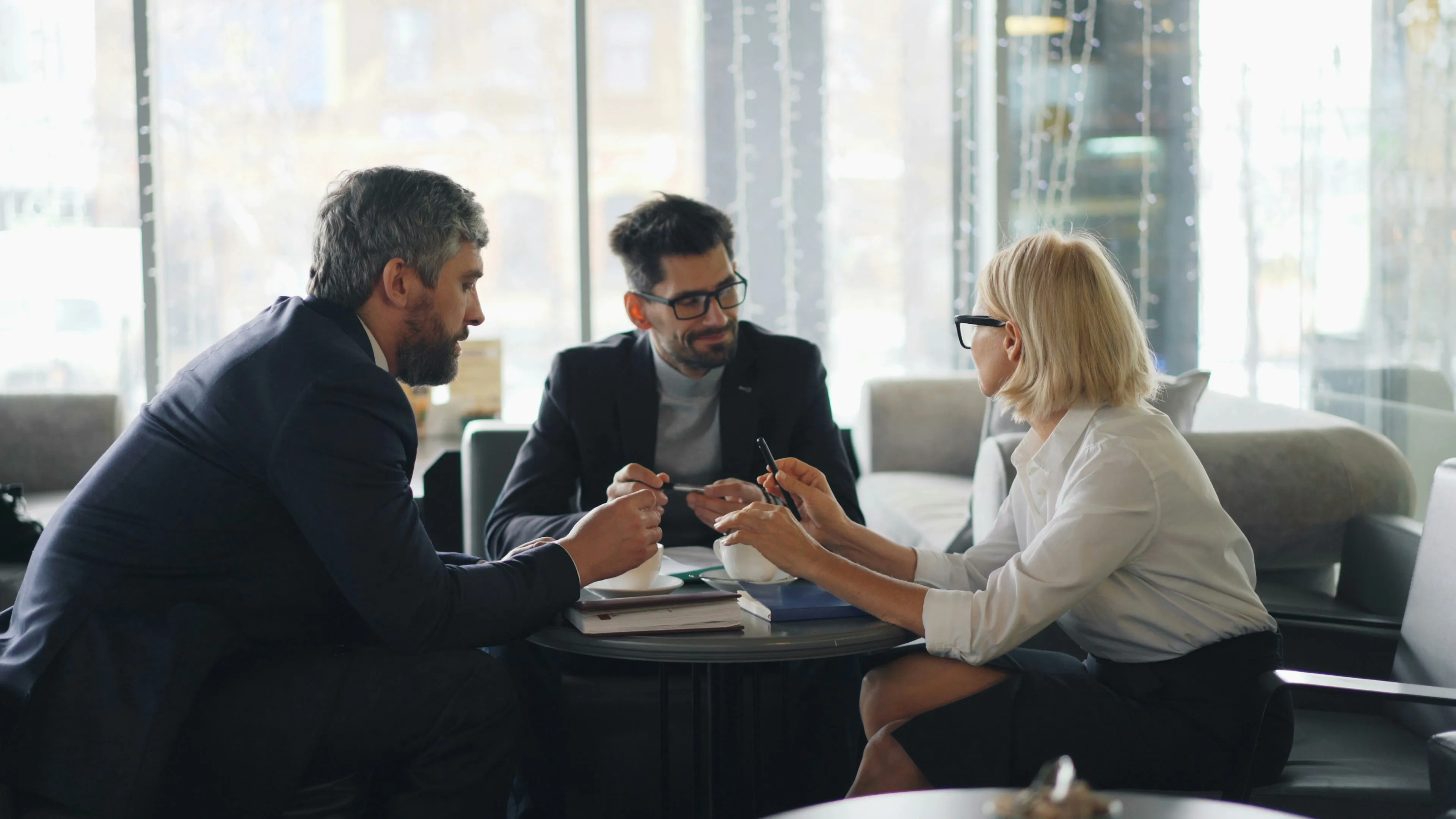 Three business professionals discussing a project together